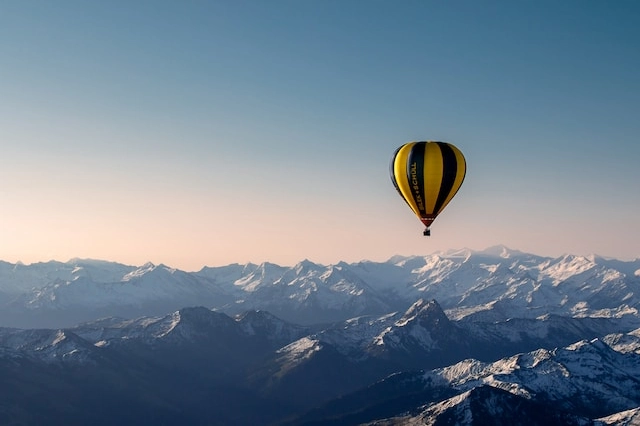 Beautiful mountains with a hot airballoon