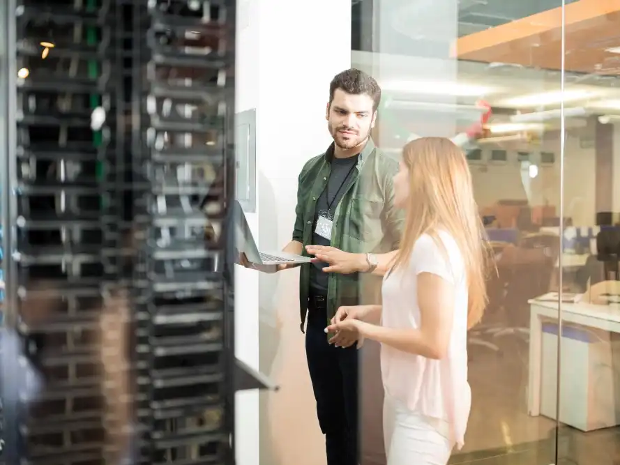 To teknikere i serverrum med laptop